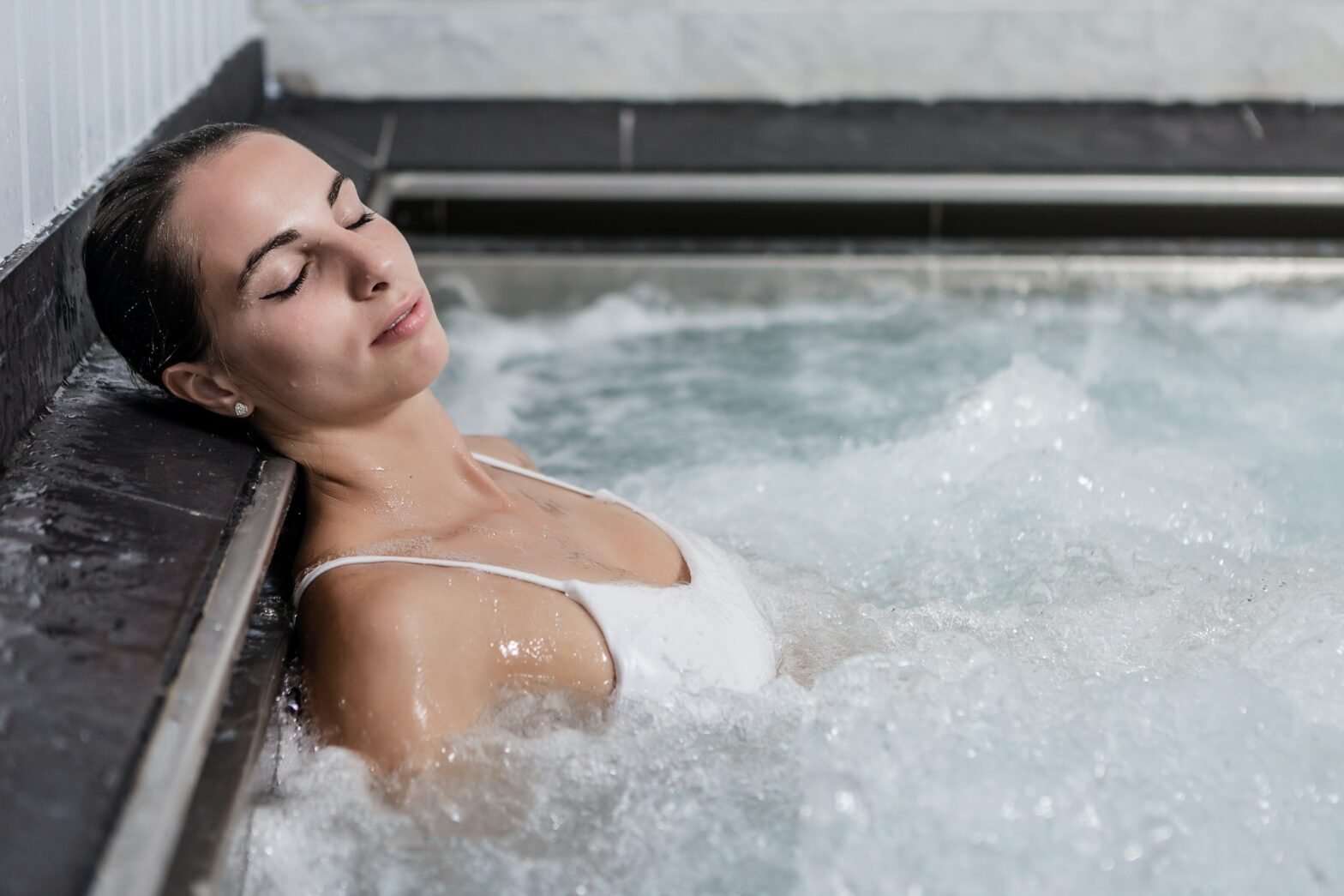 Young female relaxing in jacuzzi